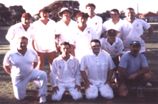 Photo of Keswick Cricket Club premiers 1999-00. Group of D-grade players with premiership cup.